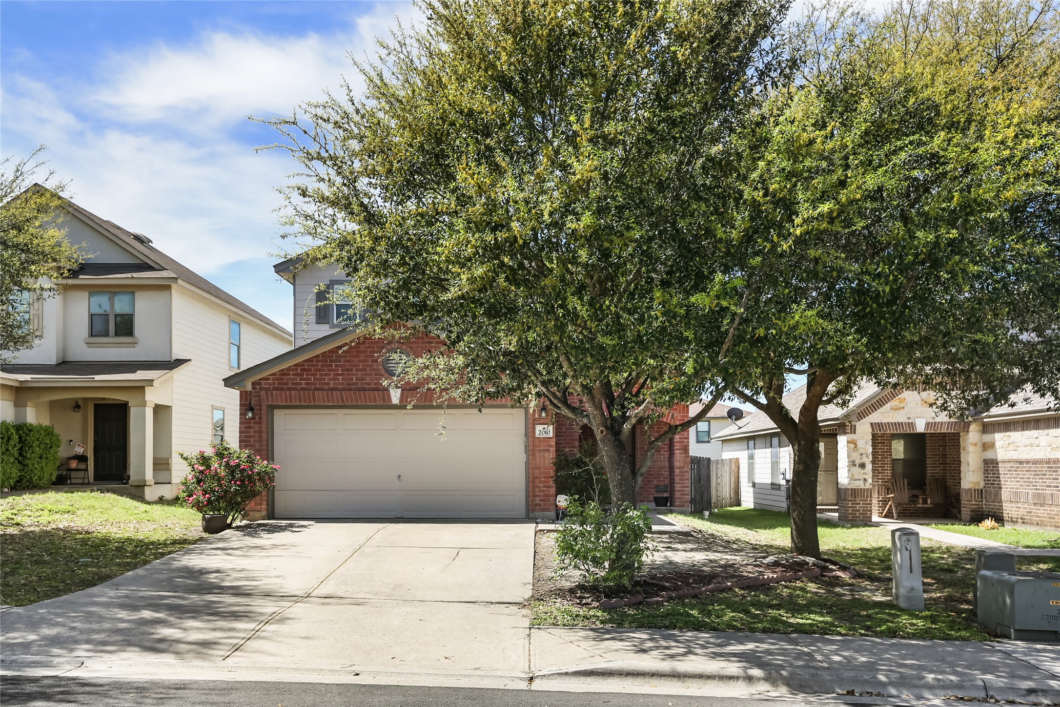 2010 Ashberry Trail Georgetown, TX 78626 - Photo 24 of 24 View of front of house featuring brick siding, driveway, and a front lawn