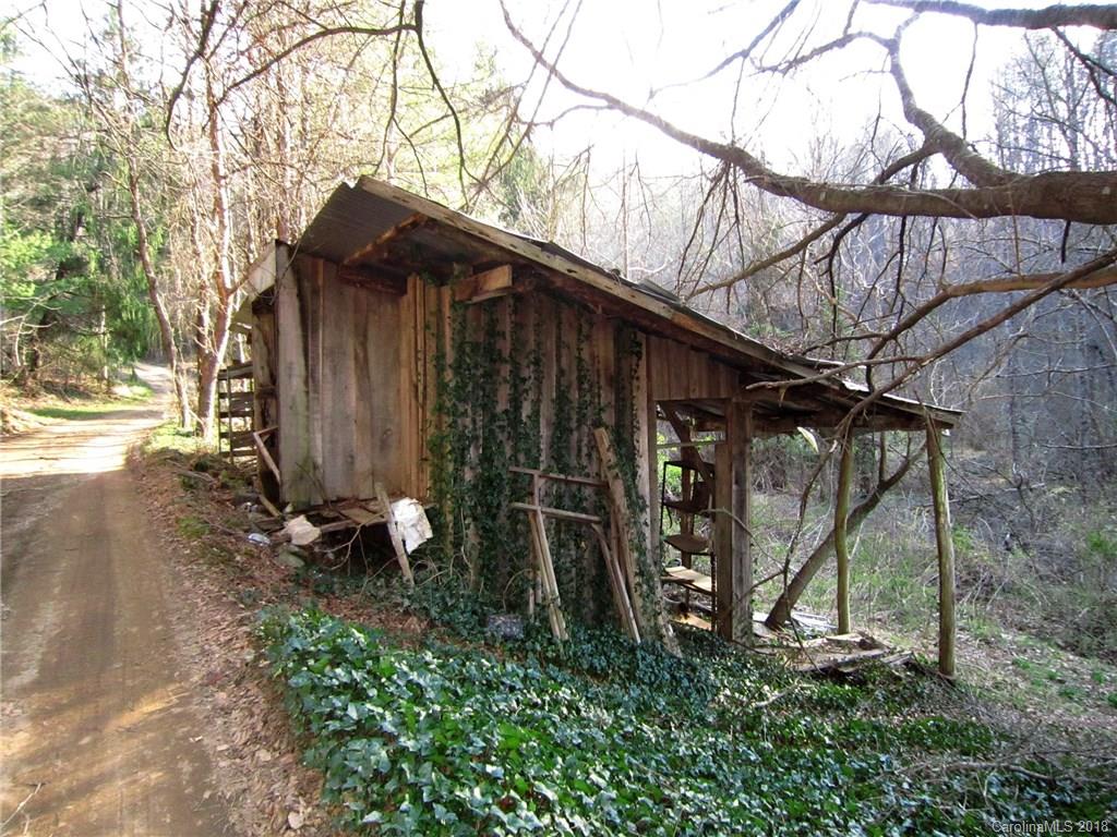 5 Fox Fire Ridge Road Leicester, NC 28748 - Photo 2 of 4 a backyard of a house with lots of green space and wooden fence