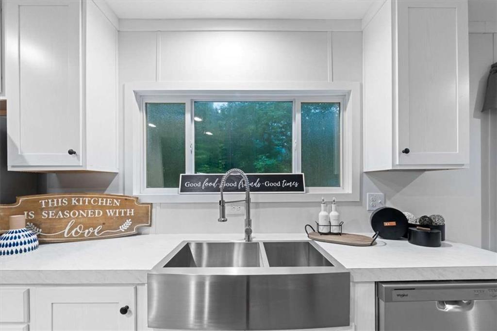 277 Napier Road Southwest Eatonton, GA 31024 - Photo 12 of 34 a kitchen with a sink cabinets and window