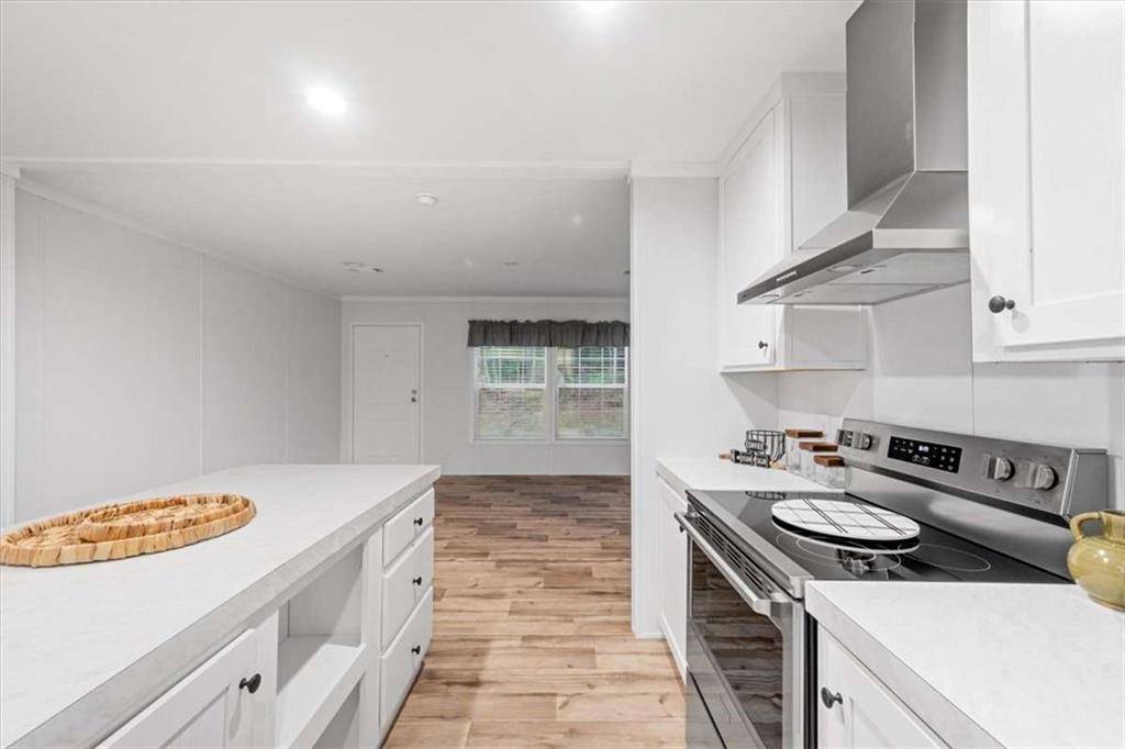 277 Napier Road Southwest Eatonton, GA 31024 - Photo 13 of 34 a kitchen with a sink stove and cabinets