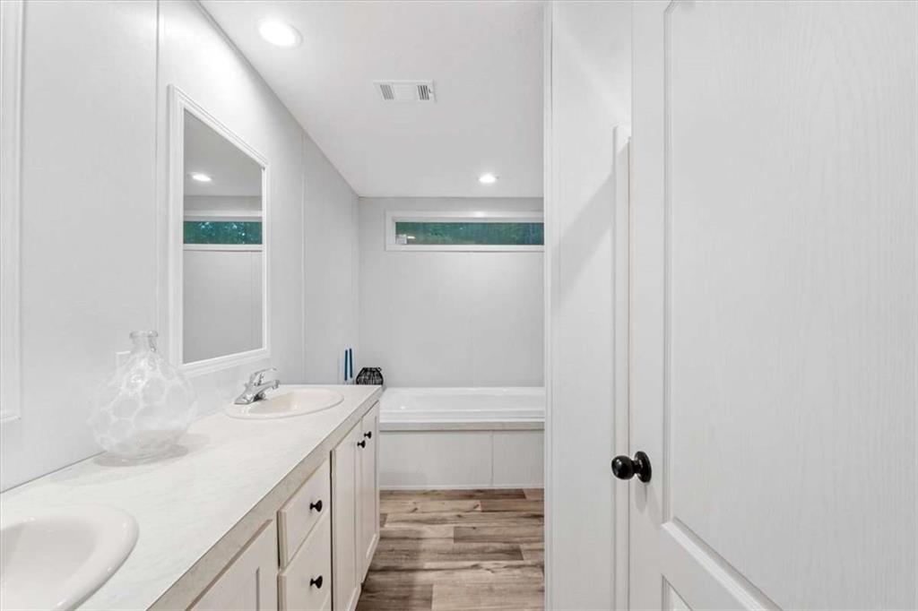 277 Napier Road Southwest Eatonton, GA 31024 - Photo 20 of 34 a bathroom with a sink a toilet and shower