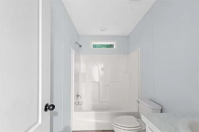 a bathroom with a toilet and shower