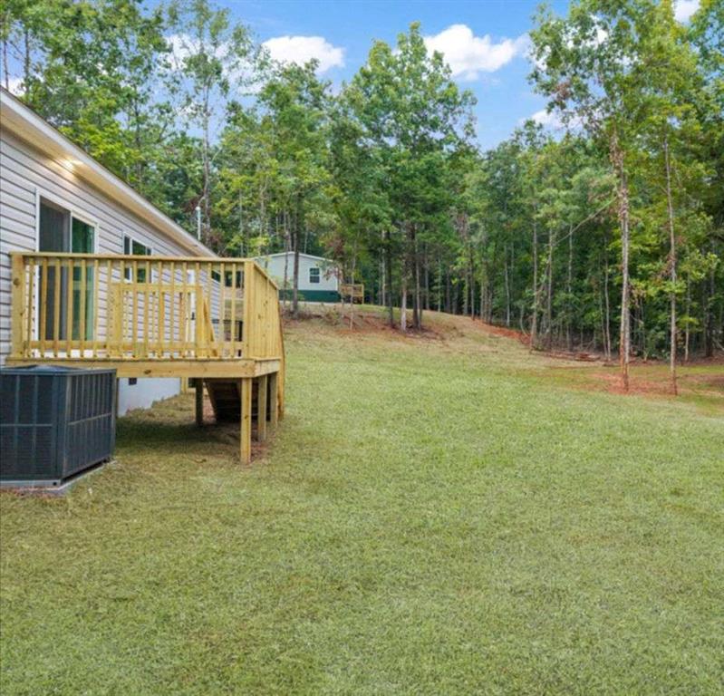 277 Napier Road Southwest Eatonton, GA 31024 - Photo 31 of 34 a backyard of a house with table and chairs