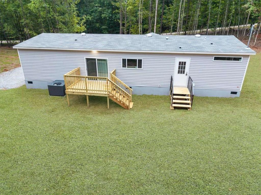 277 Napier Road Southwest Eatonton, GA 31024 - Photo 33 of 34 a view of a house with a backyard and a table