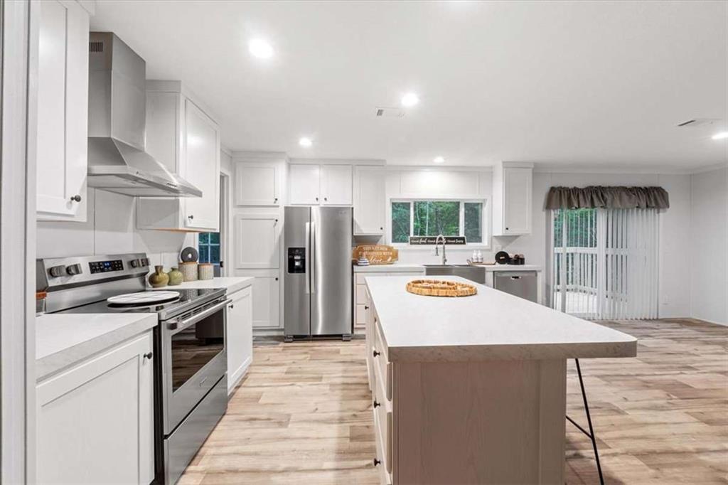 277 Napier Road Southwest Eatonton, GA 31024 - Photo 9 of 34 a kitchen with stainless steel appliances a refrigerator a sink a stove and cabinets