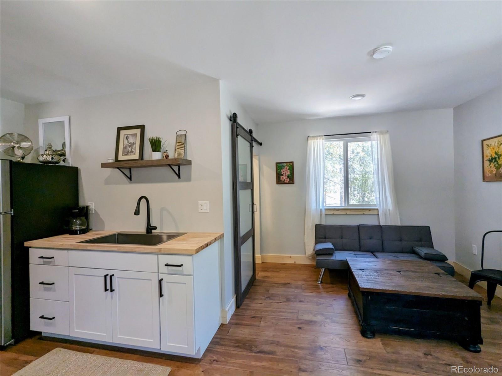200 County Road 4C-E Leadville, CO 80461 - Photo 28 of 36 a living room with a couch and a flat screen tv