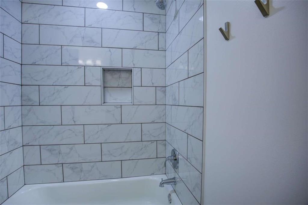 7225 Pineneedle Drive Southwest Covington, GA 30014 - Photo 28 of 37 a bathroom with a bathtub