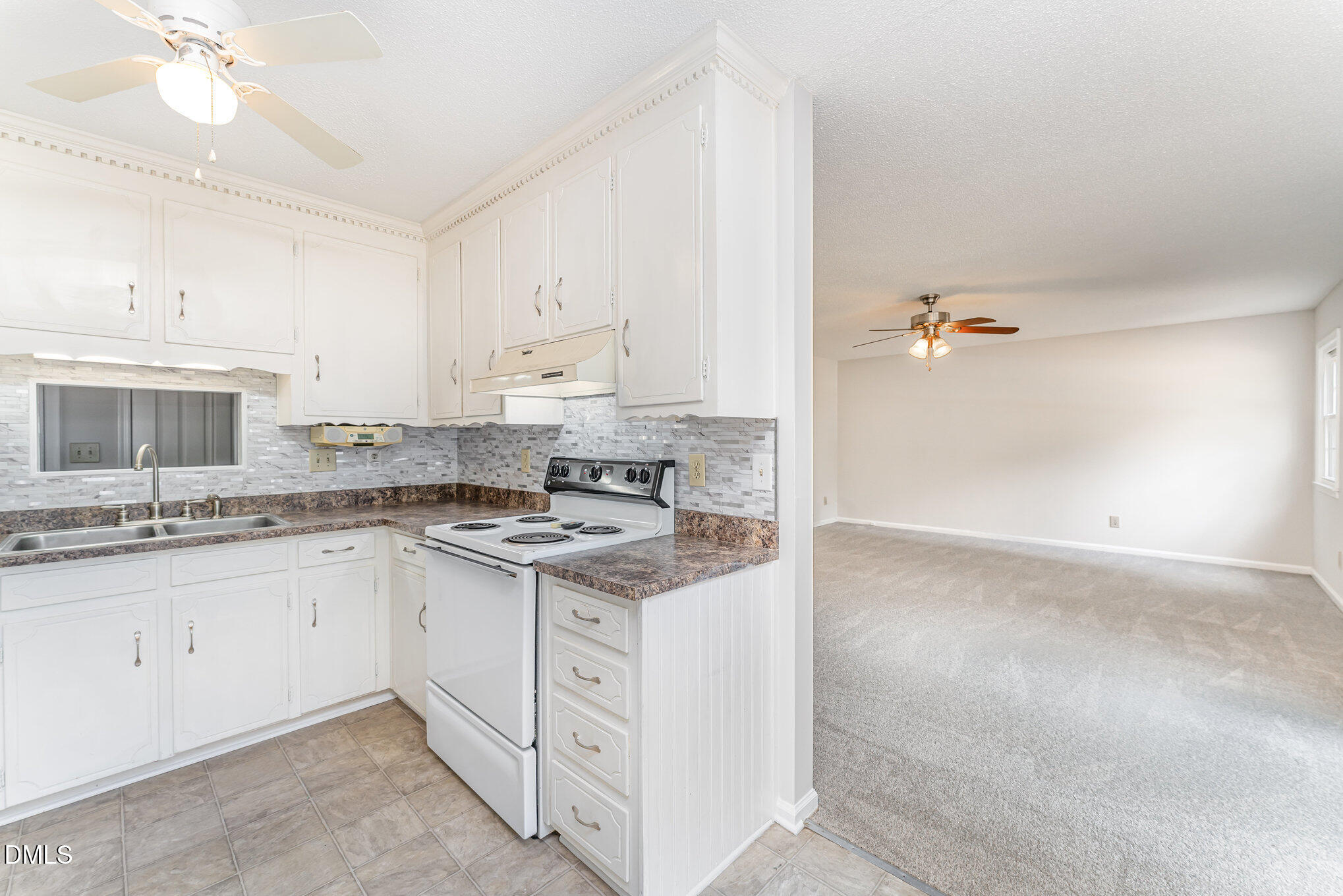110 Rose Circle Dunn, NC 28334 - Photo 13 of 37 a kitchen with granite countertop a sink stove and cabinets