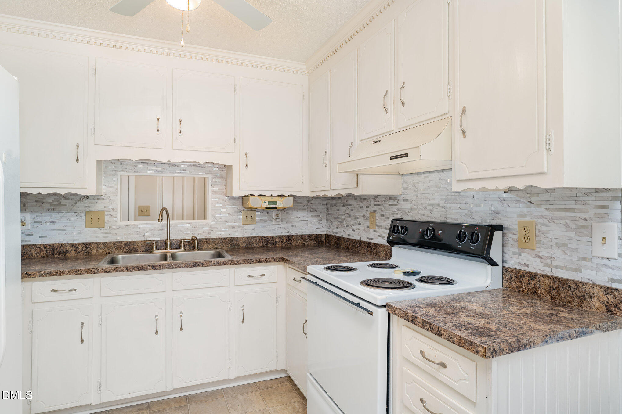 110 Rose Circle Dunn, NC 28334 - Photo 15 of 37 a kitchen with granite countertop white cabinets and white appliances