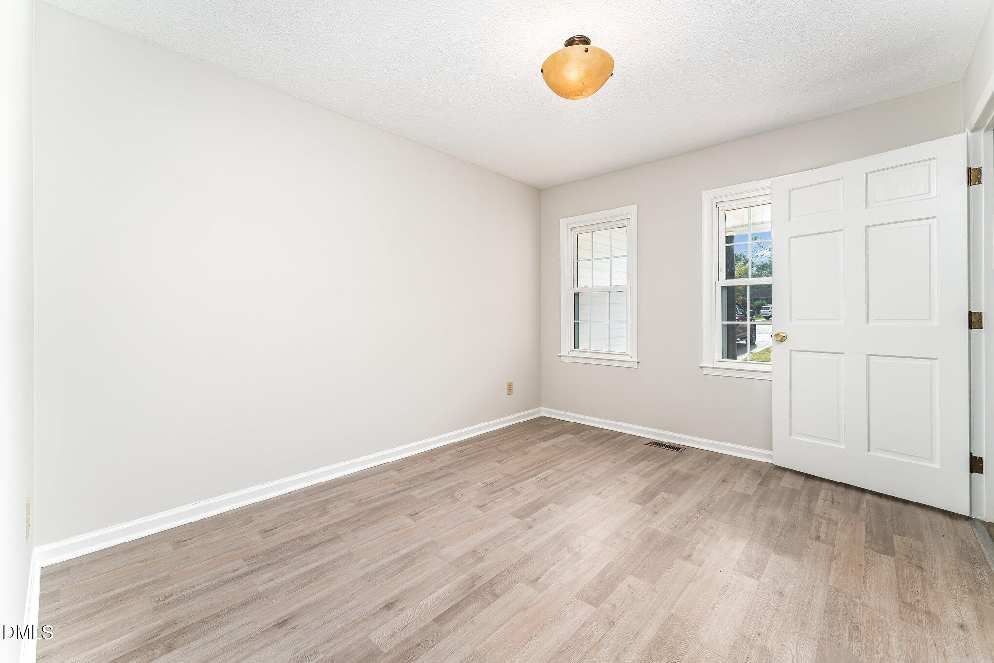 110 Rose Circle Dunn, NC 28334 - Photo 18 of 37 an empty room with wooden floor and windows