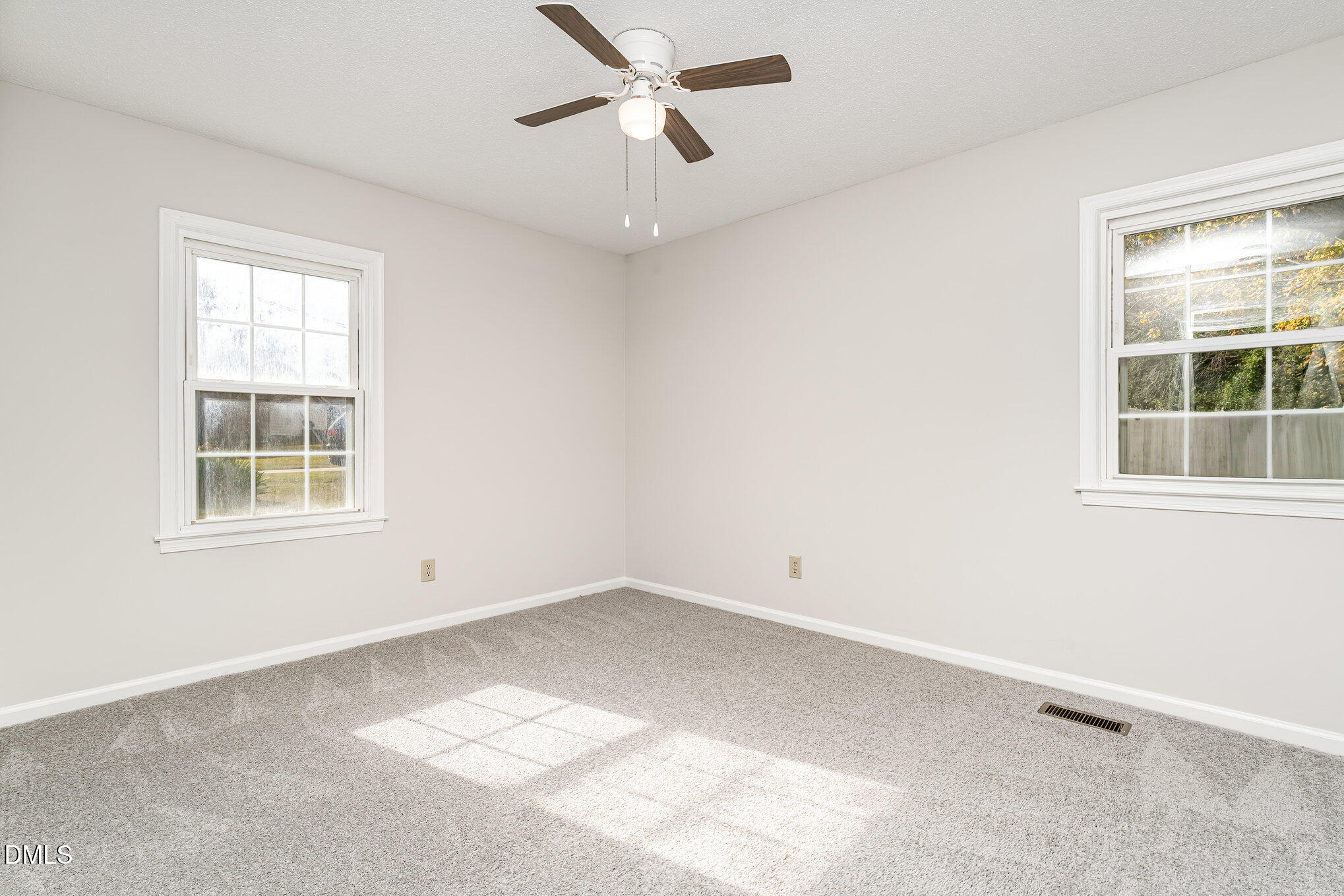 110 Rose Circle Dunn, NC 28334 - Photo 21 of 37 an empty room with a window and ceiling fan