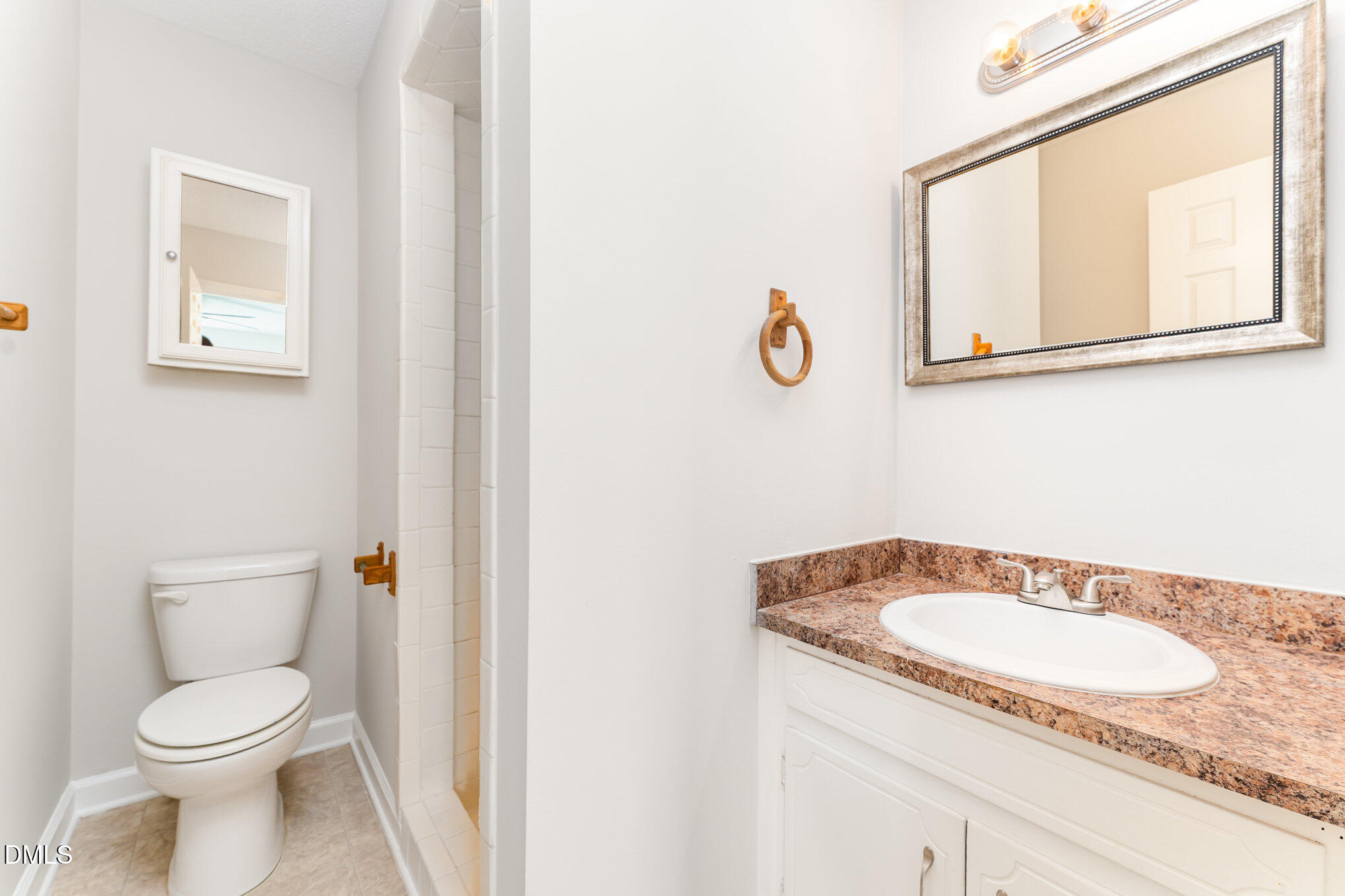 110 Rose Circle Dunn, NC 28334 - Photo 27 of 37 a bathroom with a granite countertop sink and a mirror