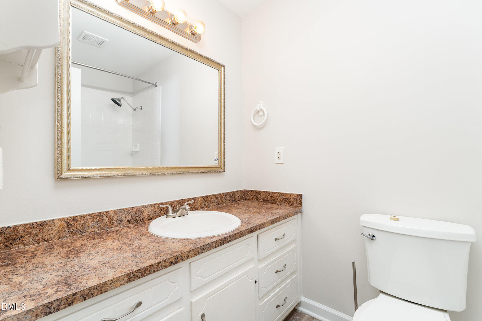 110 Rose Circle Dunn, NC 28334 - Photo 28 of 37 a bathroom with a granite countertop sink and a mirror