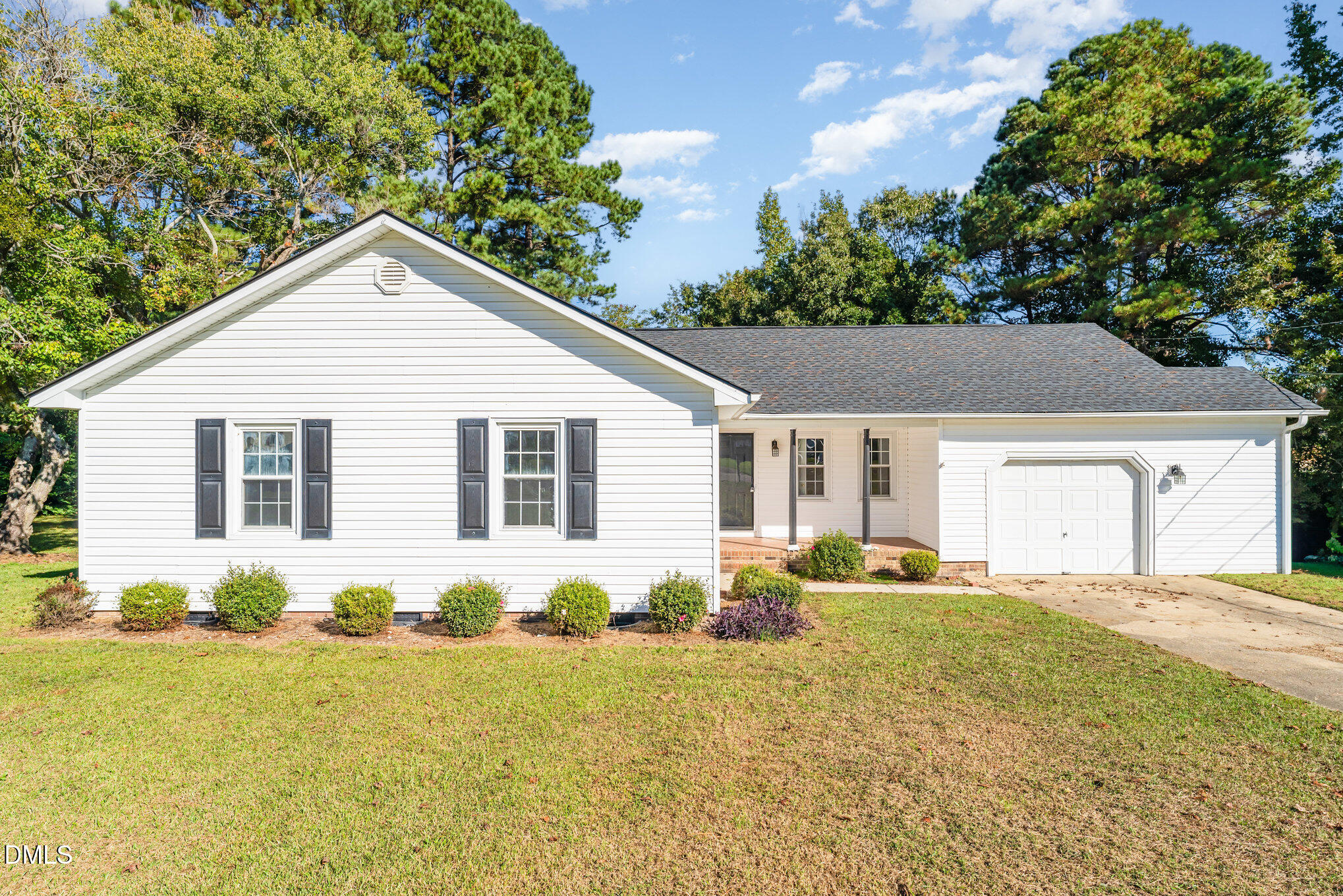 110 Rose Circle Dunn, NC 28334 - Photo 5 of 37 a front view of house with yard and trees in the background