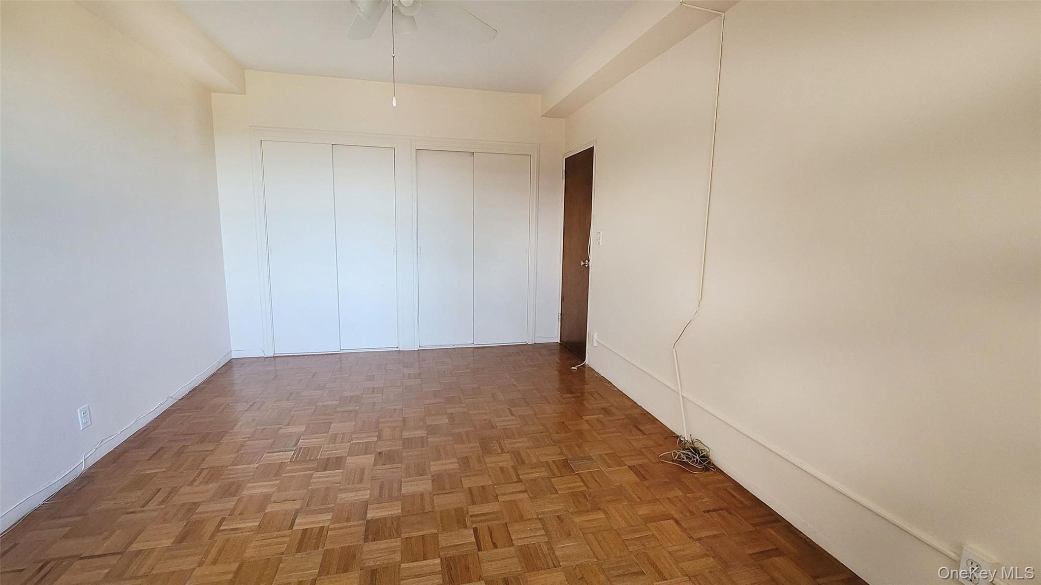 99-72 66th Road, Unit 7AA Queens, NY 11374 - Photo 14 of 19 Empty room with a ceiling fan and baseboards