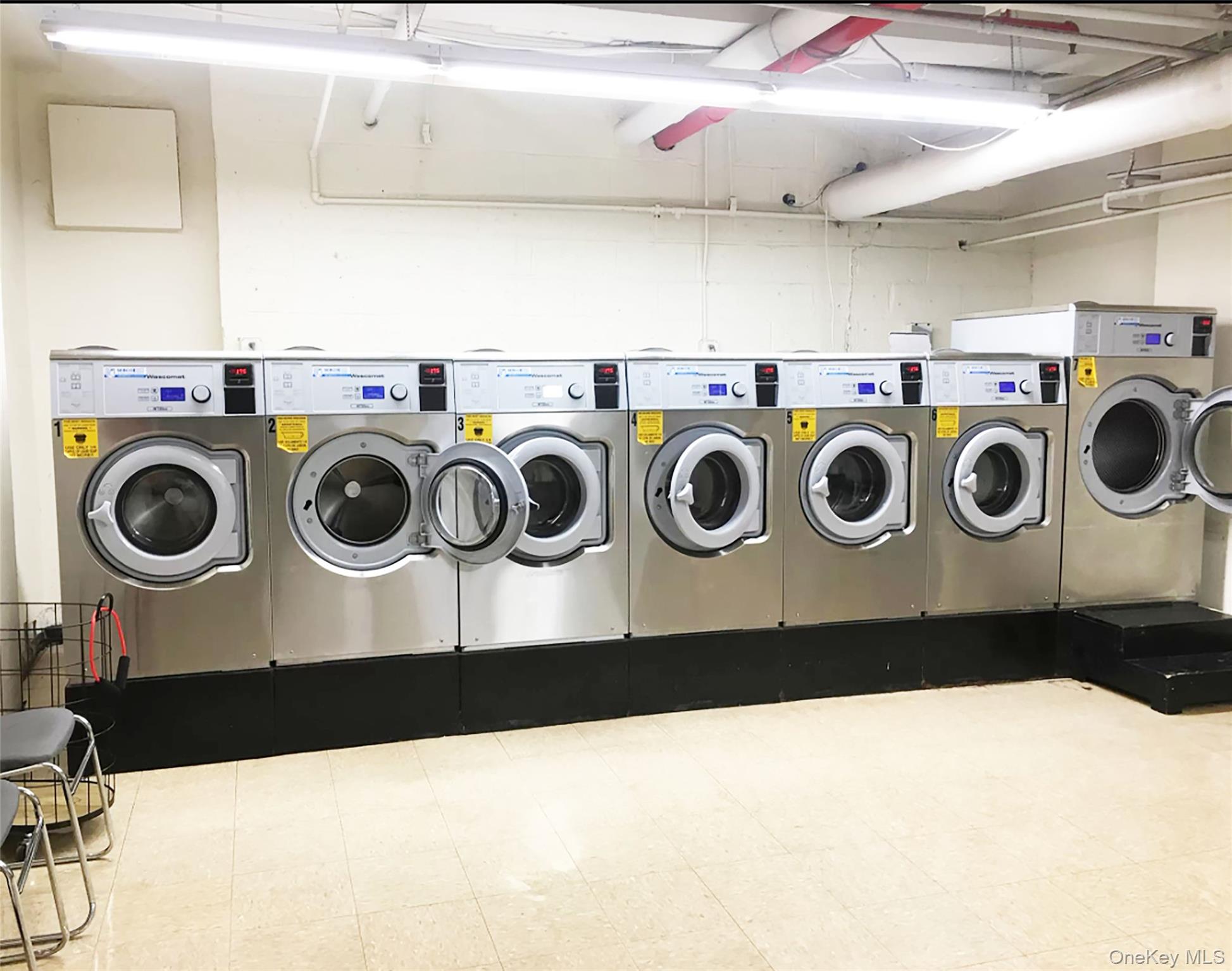 99-72 66th Road, Unit 7AA Queens, NY 11374 - Photo 18 of 19 Shared laundry featuring washing machine and clothes dryer and tile patterned floors