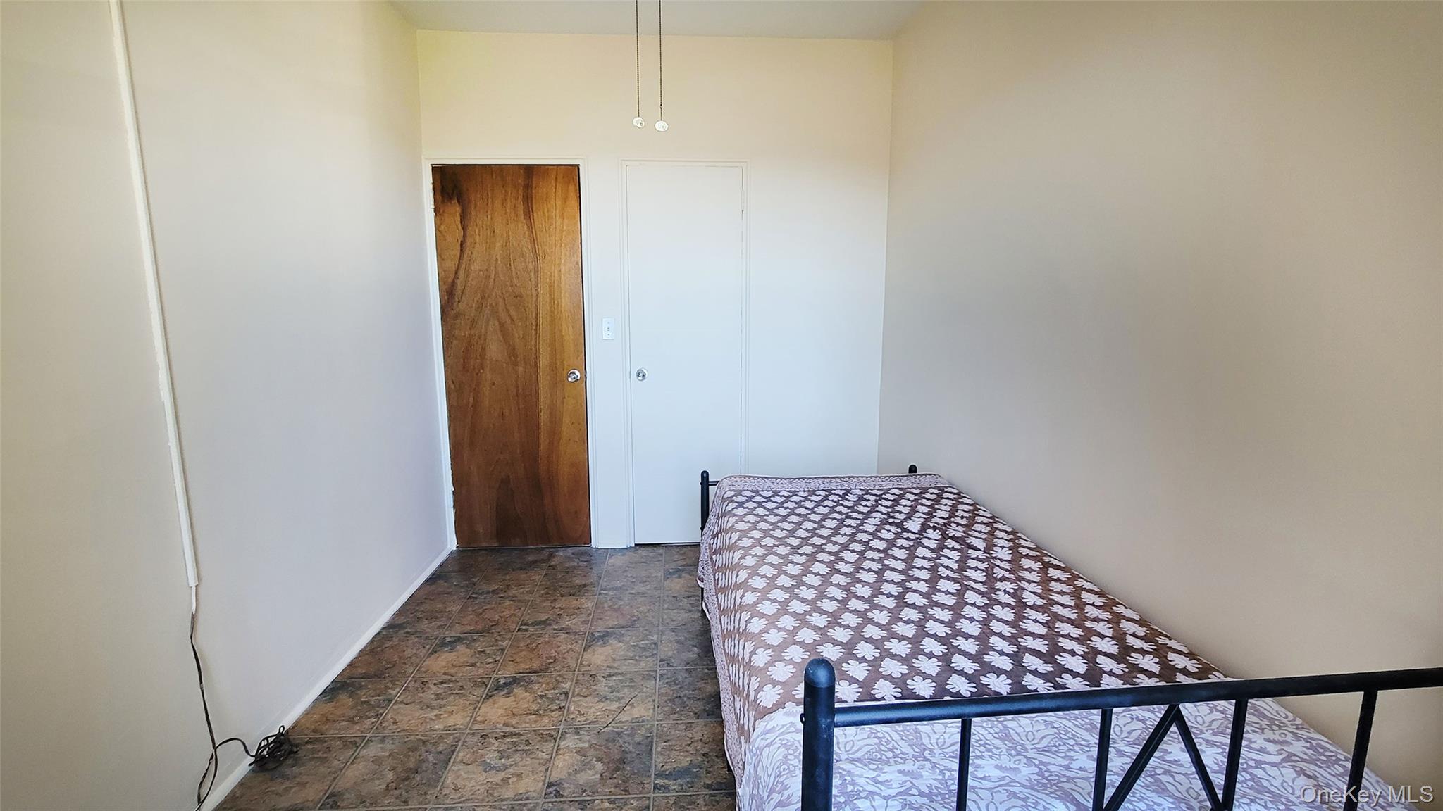 99-72 66th Road, Unit 7AA Queens, NY 11374 - Photo 8 of 19 Bedroom featuring dark stone finish floors and baseboards