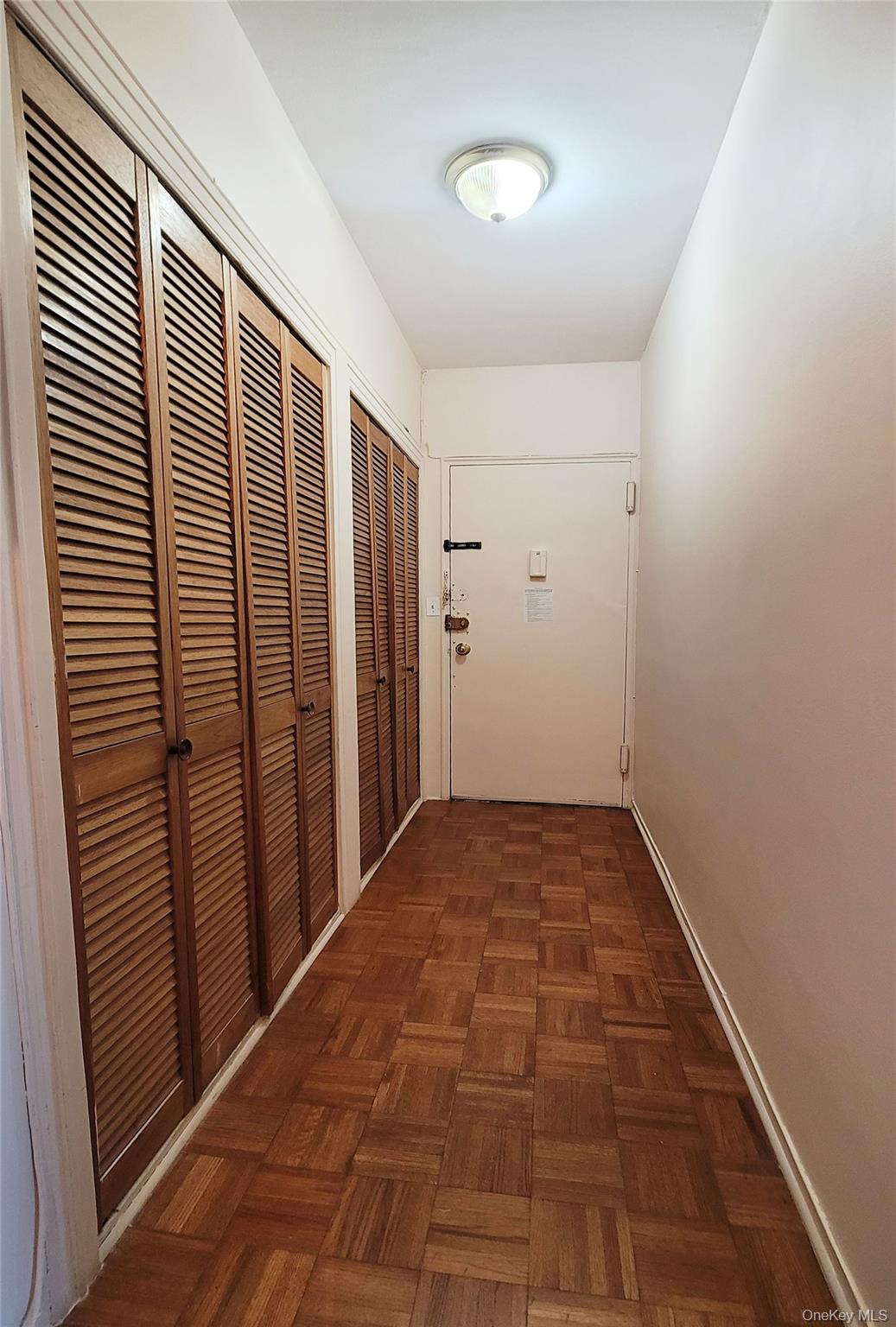 99-72 66th Road, Unit 7AA Queens, NY 11374 - Photo 10 of 19 Hallway with baseboards