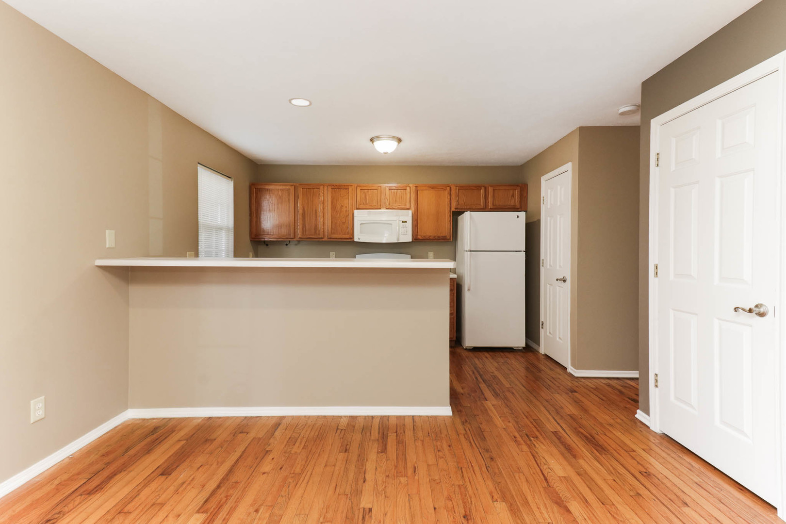 230 Parktrail Road Normal, IL 61761 - Photo 6 of 37 a view of a kitchen with a fridge and wooden floor