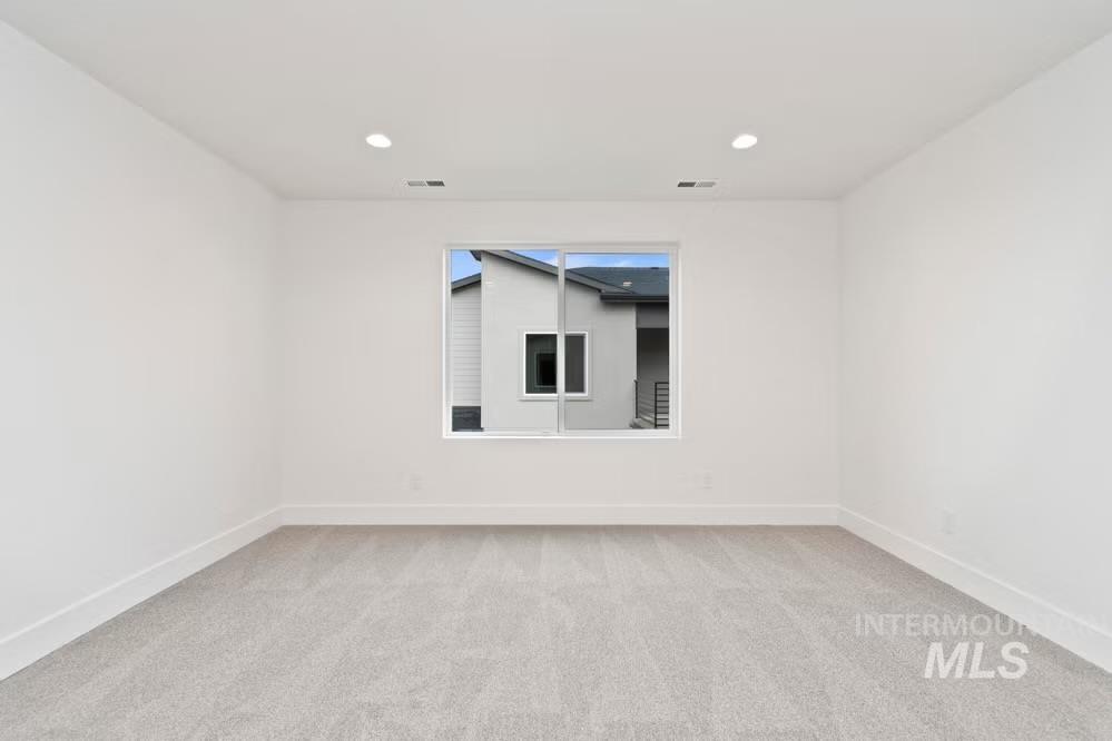 744 South Calhoun Lane Star, ID 83669 - Photo 12 of 34 Unfurnished room with light colored carpet and recessed lighting