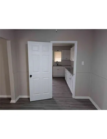 a living room with a couch and wooden floor