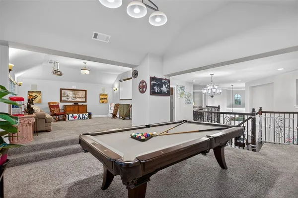 a room with furniture and pool table