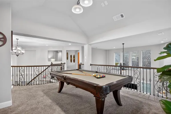 a room with furniture pool table and windows