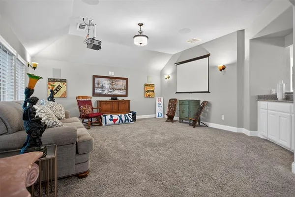 a living room with furniture and painting on the wall