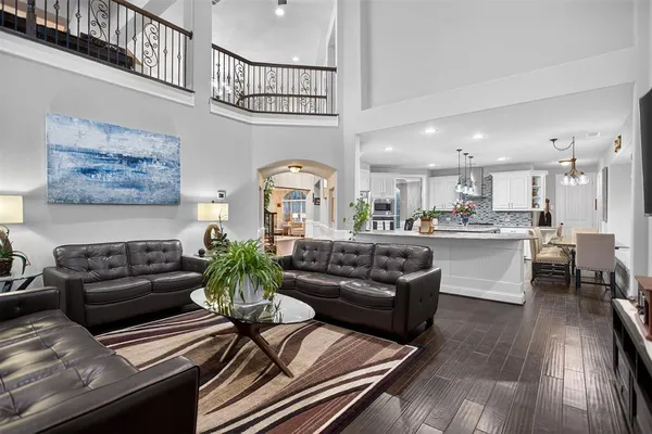 a living room with furniture dining area and a chandelier