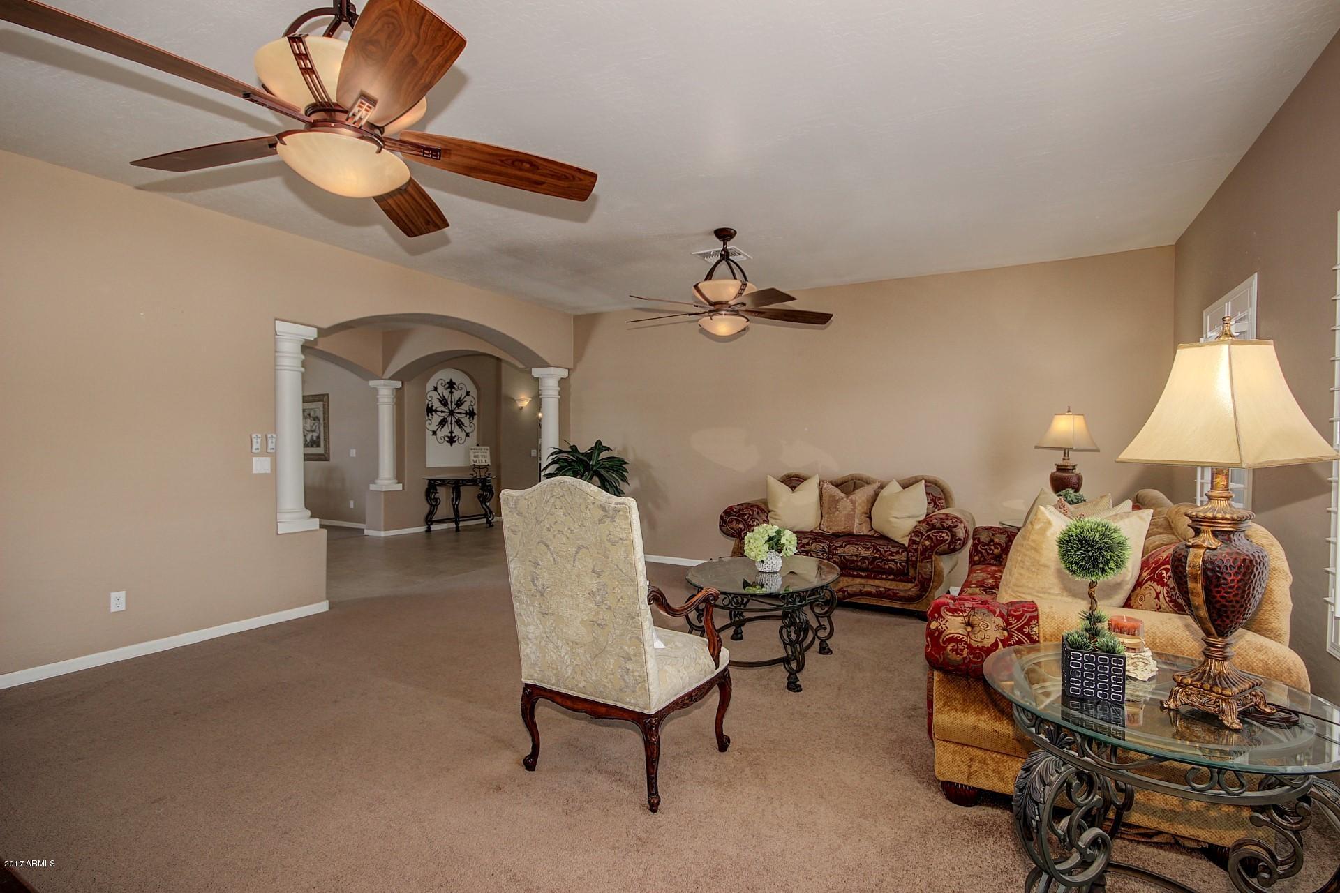 21982 East Rosa Road Queen Creek, AZ 85142 - Photo 11 of 40 a living room with furniture and a chandelier