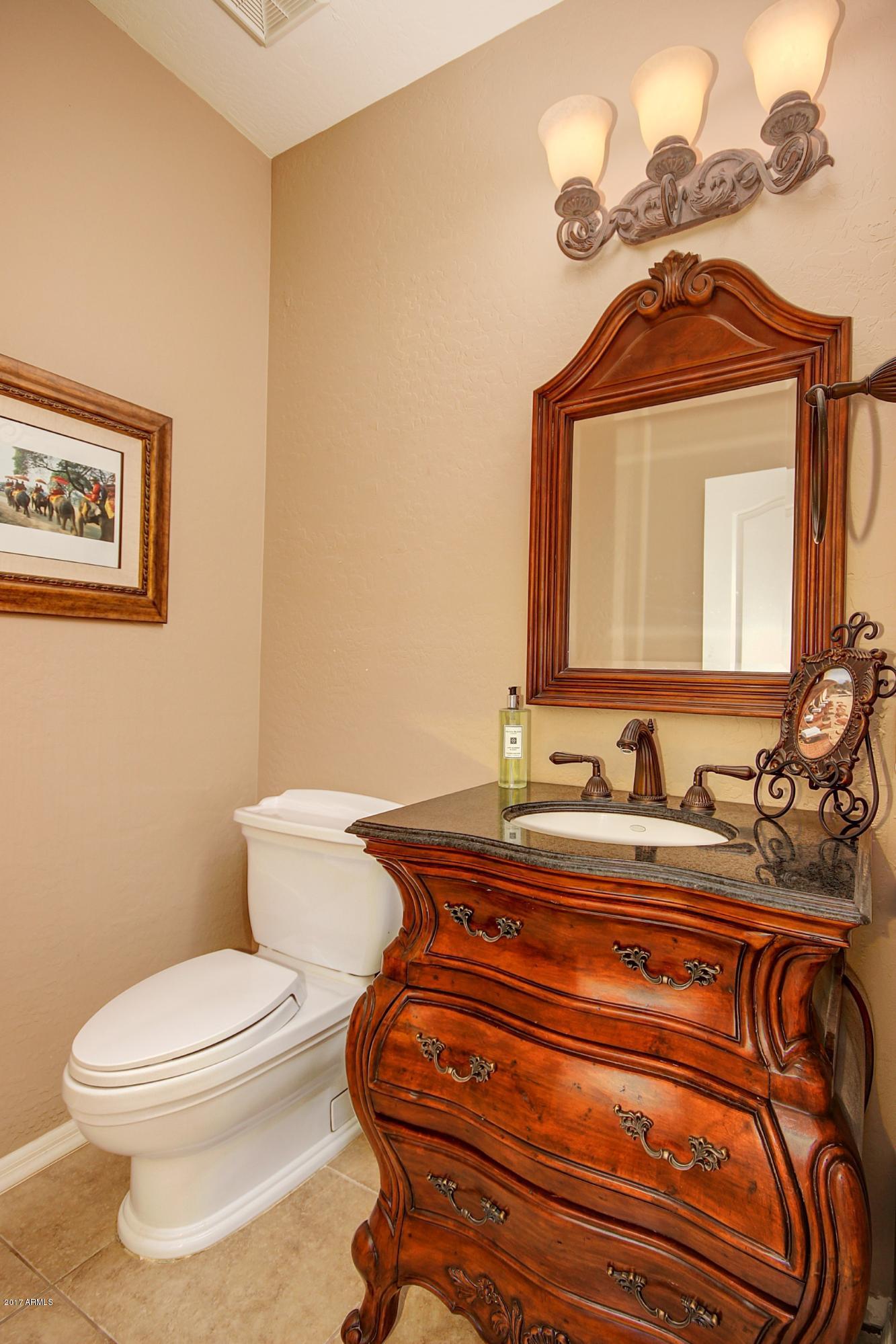 21982 East Rosa Road Queen Creek, AZ 85142 - Photo 12 of 40 a bathroom with a toilet sink and mirror