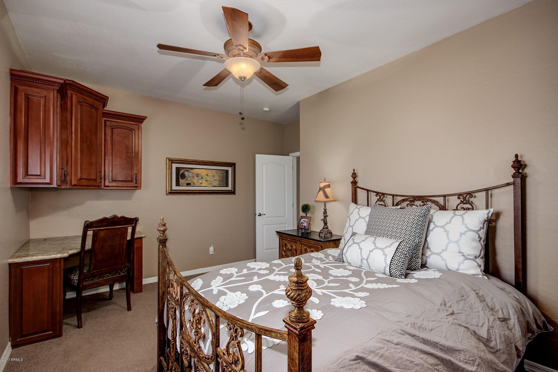21982 East Rosa Road Queen Creek, AZ 85142 - Photo 21 of 40 a bedroom with a bed and a chandelier