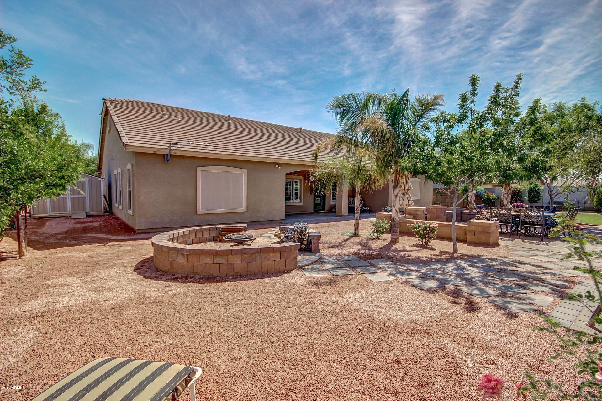 21982 East Rosa Road Queen Creek, AZ 85142 - Photo 40 of 40 a view of a backyard with table and chairs and potted plants