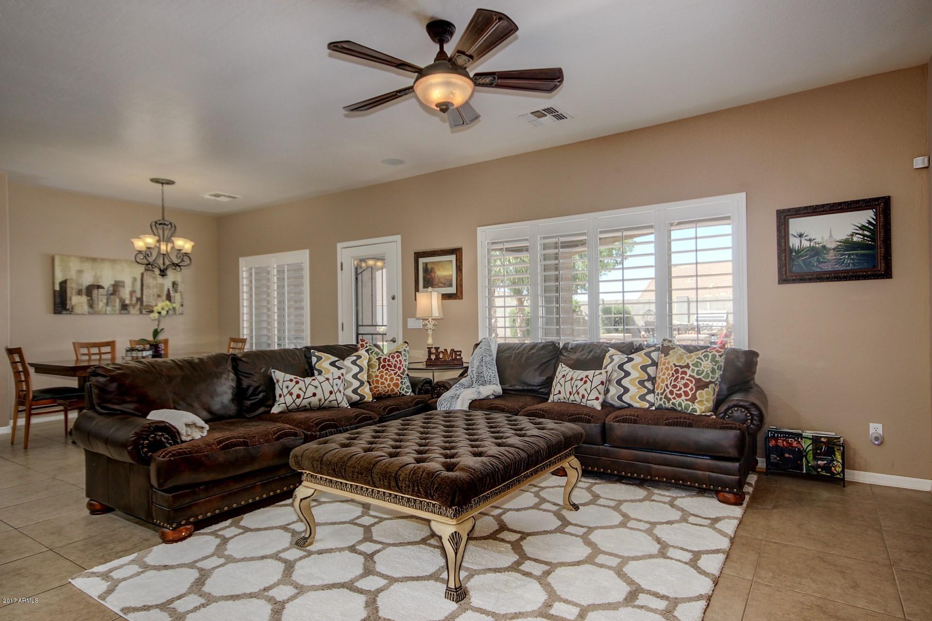 21982 East Rosa Road Queen Creek, AZ 85142 - Photo 4 of 40 a living room with furniture ceiling fan and a window