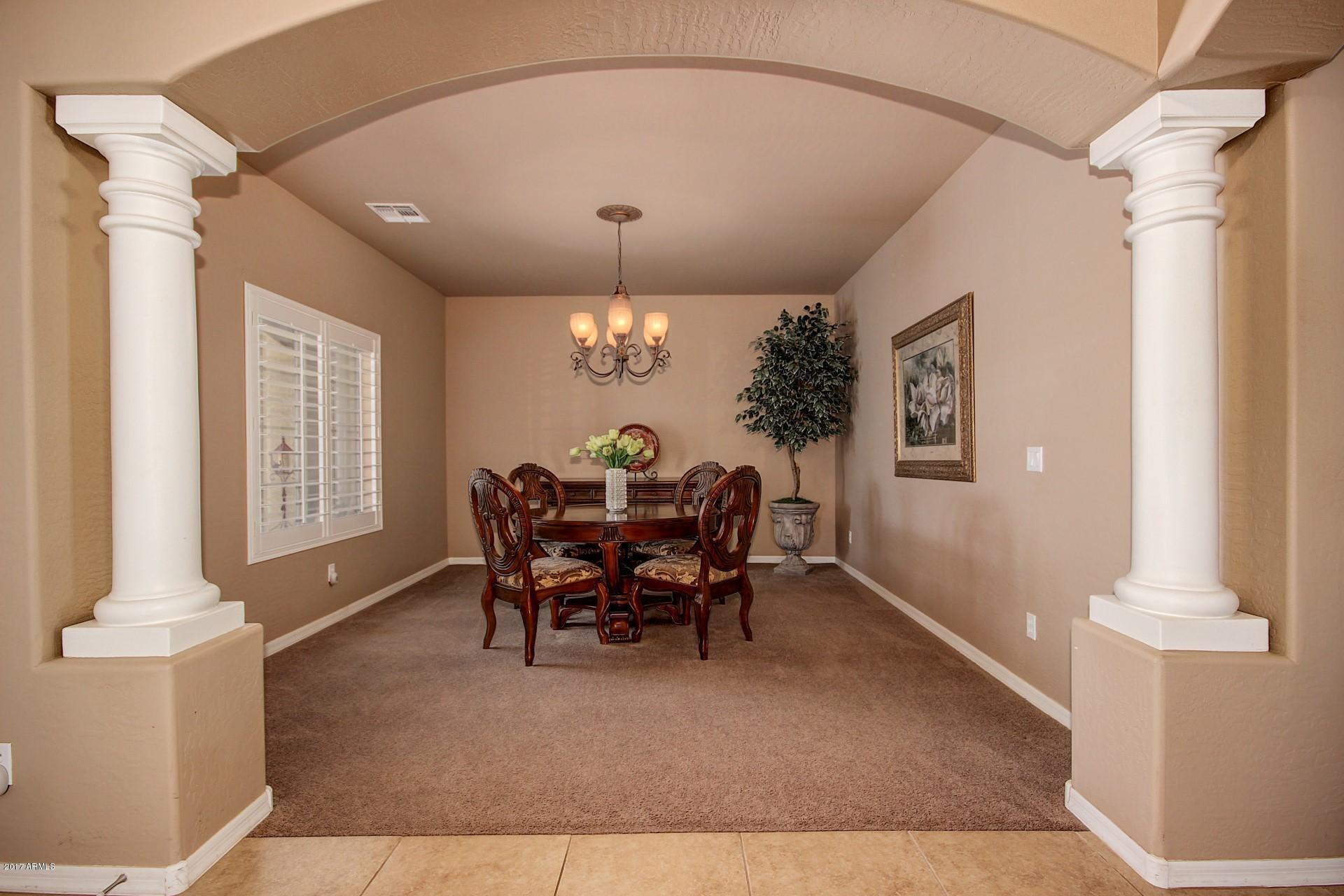 21982 East Rosa Road Queen Creek, AZ 85142 - Photo 9 of 40 a view of a dining room with furniture and chandelier