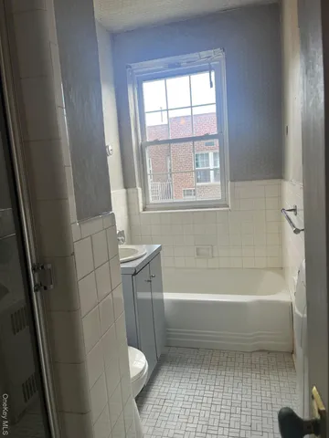a bathroom with a bathtub a toilet and a shower