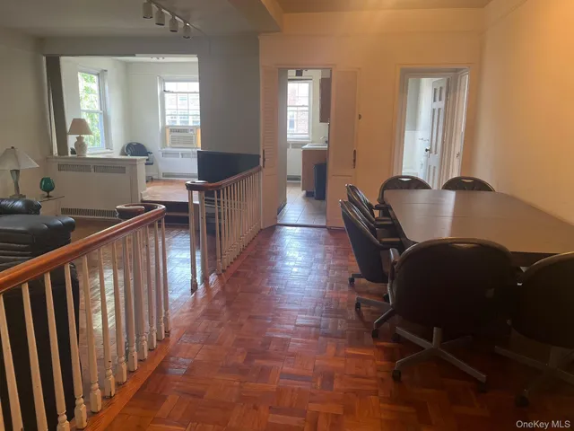 a view of a hallway with furniture and windows