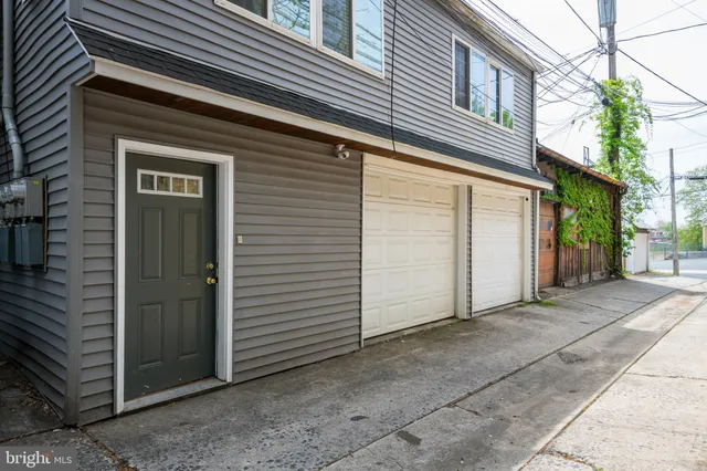 a view of a house with a door and wooden walls