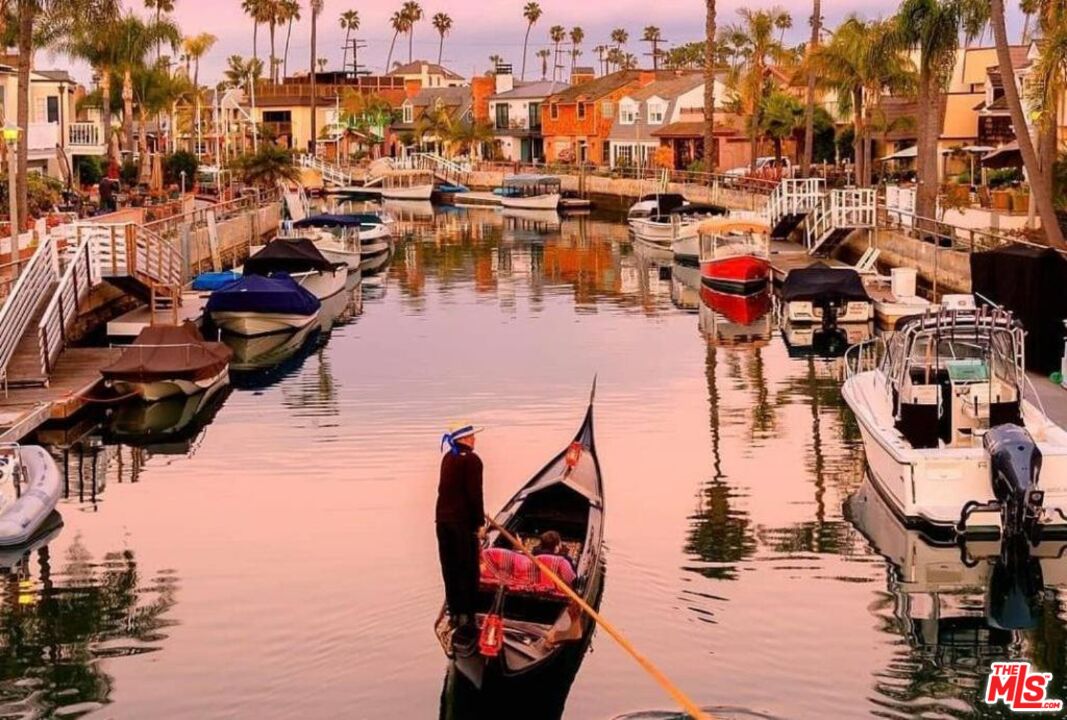 a view of water and residential houses with outdoor space