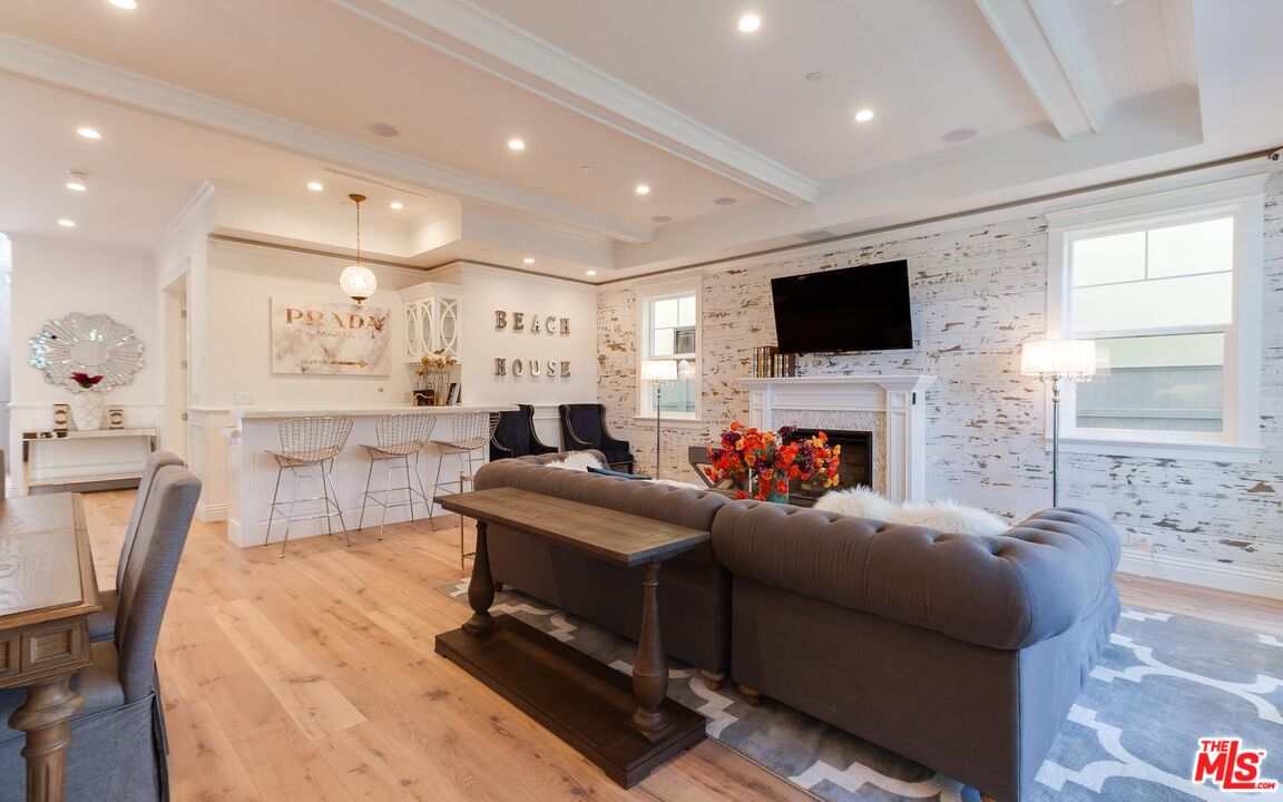 109 Geneva Walk Long Beach, CA 90803 - Photo 19 of 53 a living room with furniture a flat screen tv and a fireplace