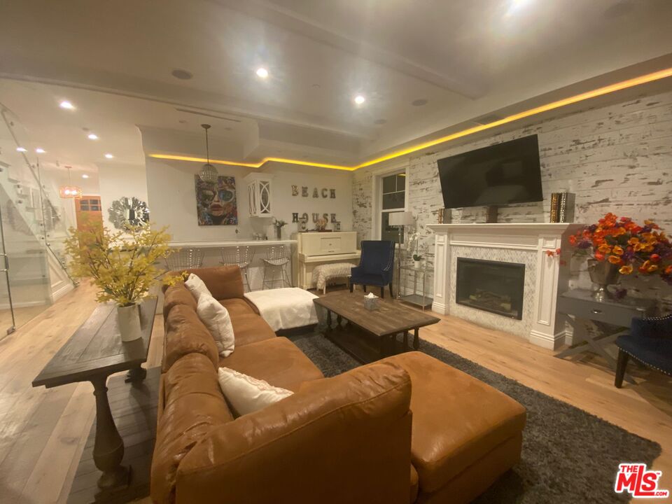 109 Geneva Walk Long Beach, CA 90803 - Photo 20 of 53 a living room with furniture a flat screen tv and a fireplace
