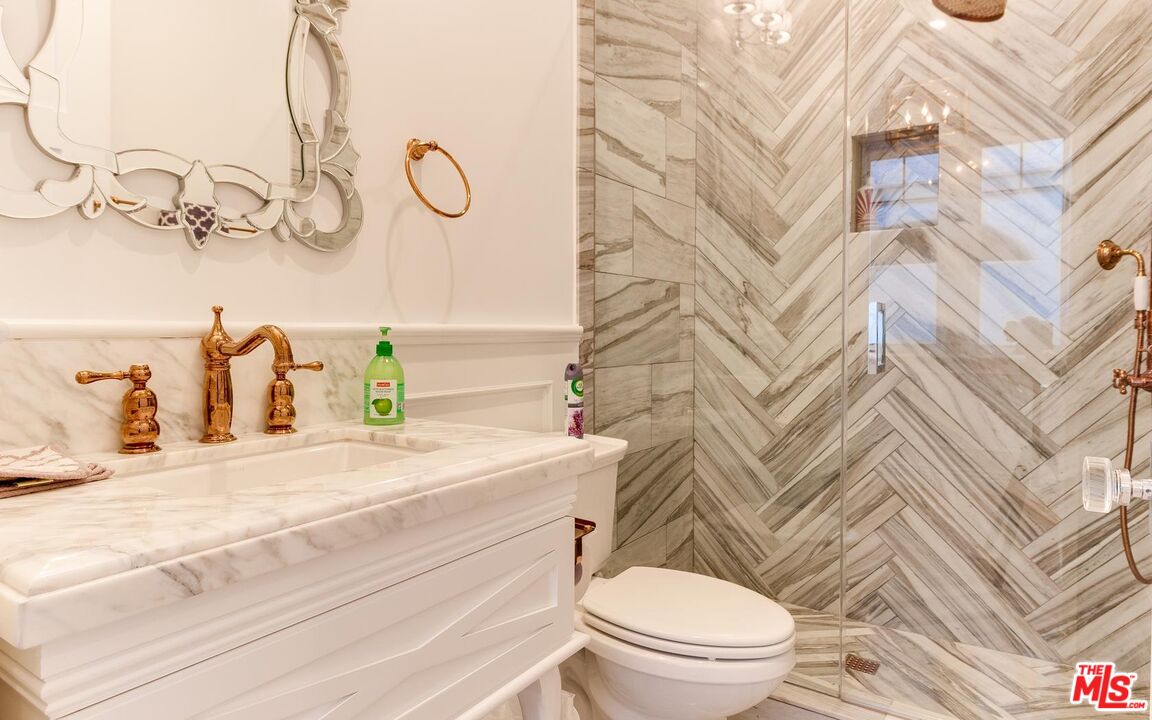 109 Geneva Walk Long Beach, CA 90803 - Photo 22 of 53 a bathroom with a granite countertop sink mirror vanity and toilet