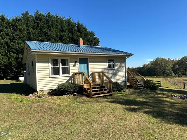 a view of a car park in front of a house