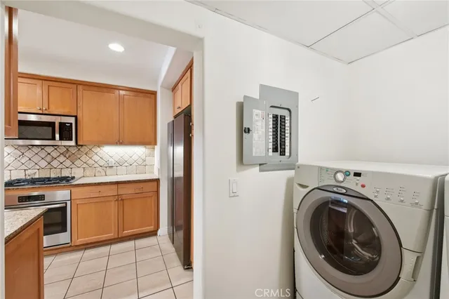 a kitchen with granite countertop a sink a stove top oven and stainless steel appliances