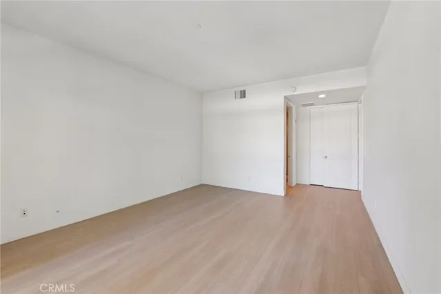 a view of an empty room and wooden floor