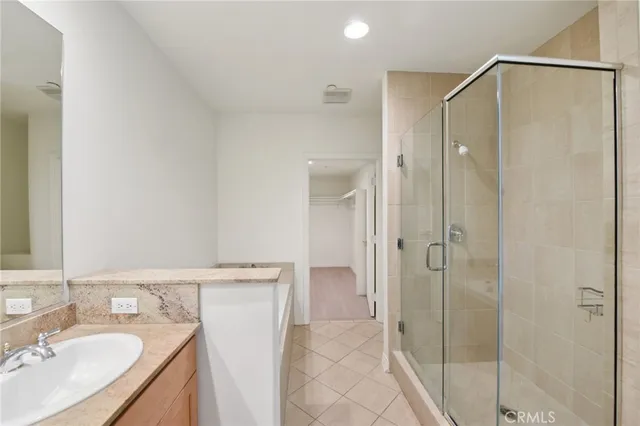a bathroom with a granite countertop sink a shower and a mirror