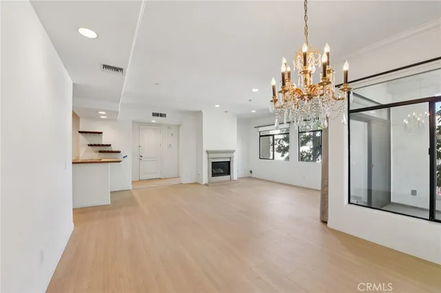 a view of a kitchen with a sink and refrigerator