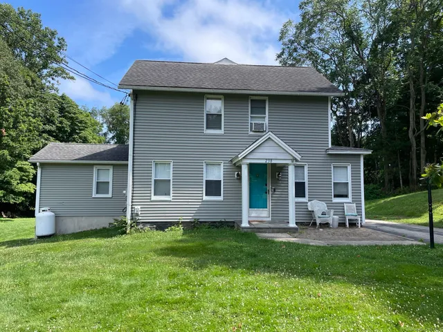 a front view of a house with garden