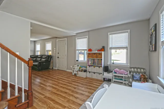a bedroom with furniture and a wooden floor