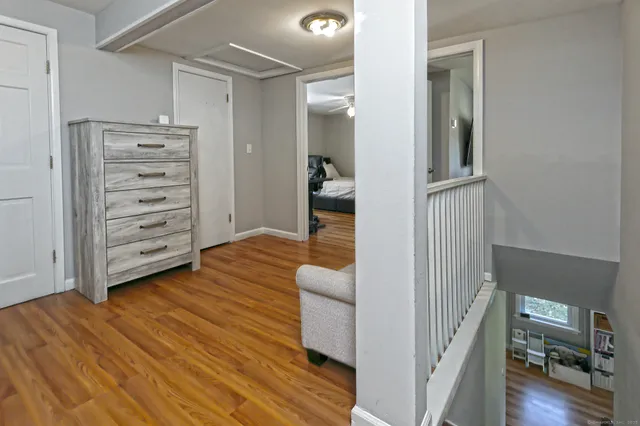 a view of a hallway with wooden floor